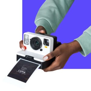 Man holding polaroid type camera
