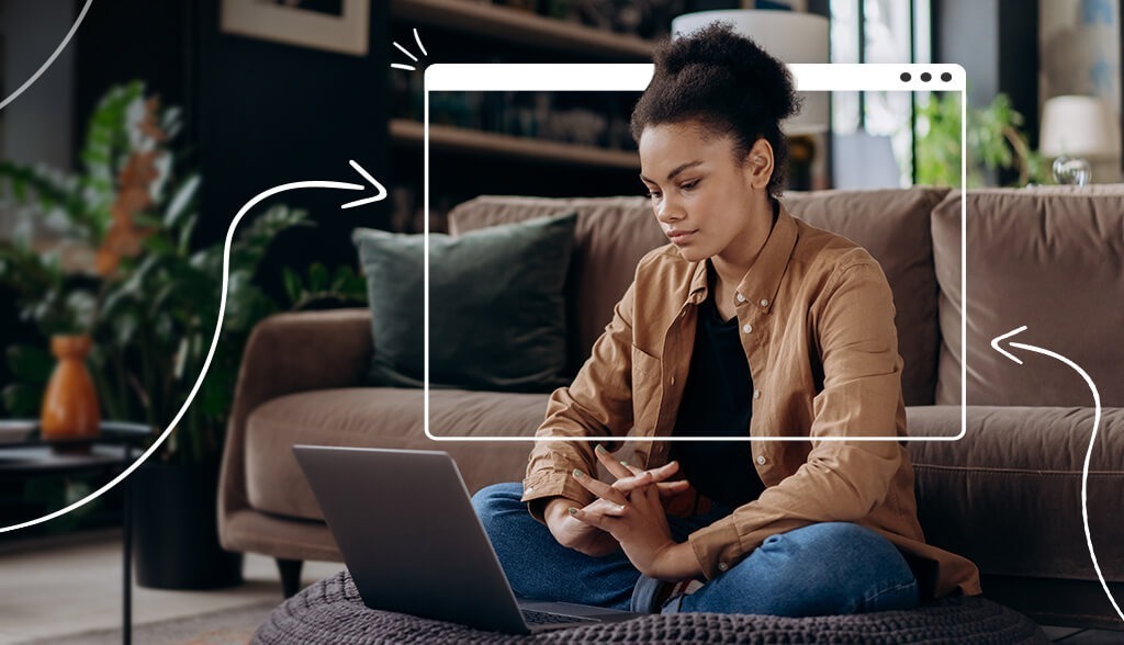 black woman sitting on couch in front of laptop