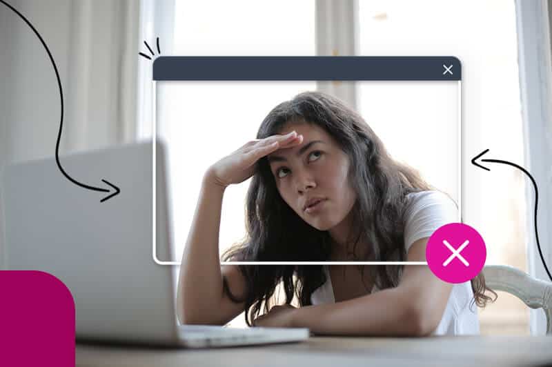 woman sitting in front of computer with hand on head