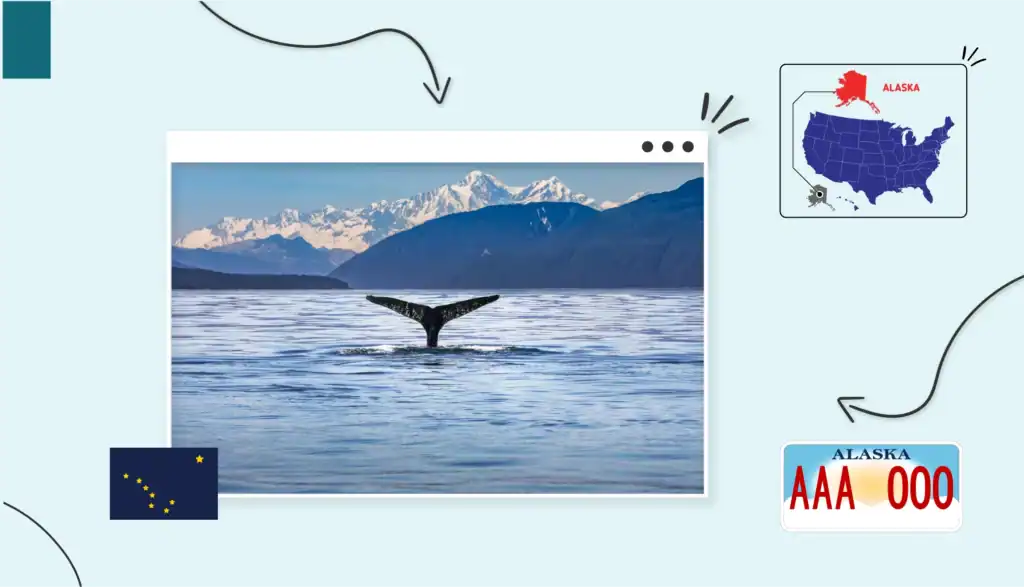 A whale's tail coming out of the ocean surrounded by snowy mountains in Alaska