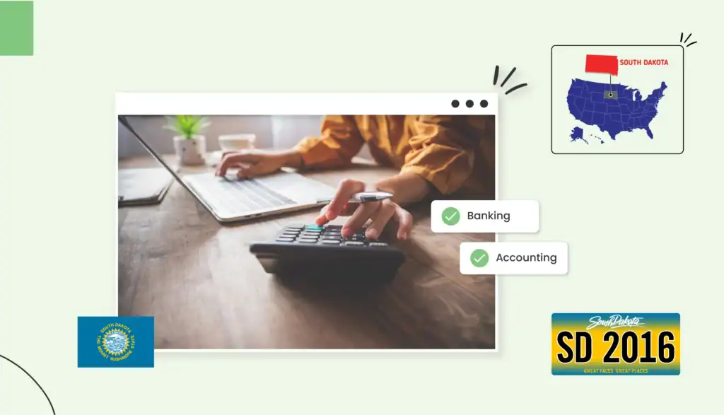 Small business owner using a calculator and typing on the computer in South Dakota