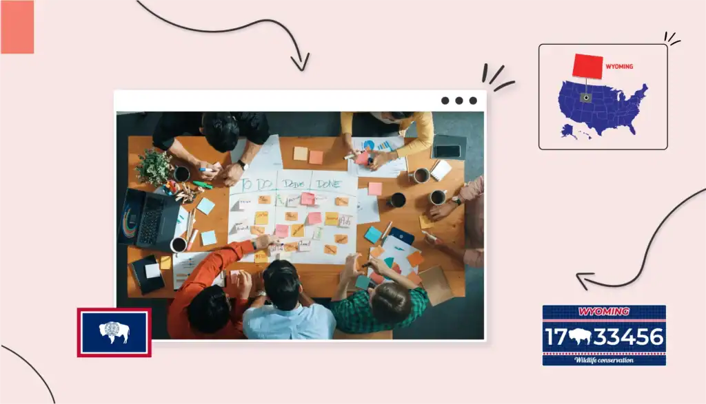 A birds-eye-view of several small business owners sitting around a table writing "to-do" sticky notes in Wyoming 