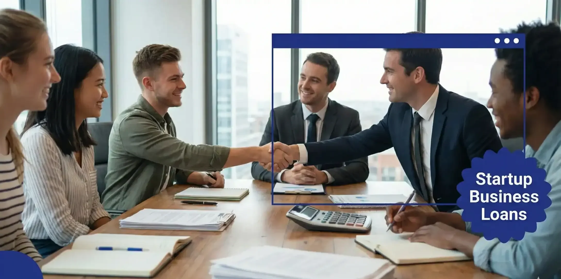 A group of young people sitting around a table with two men in ties. There are files and papers on the desk