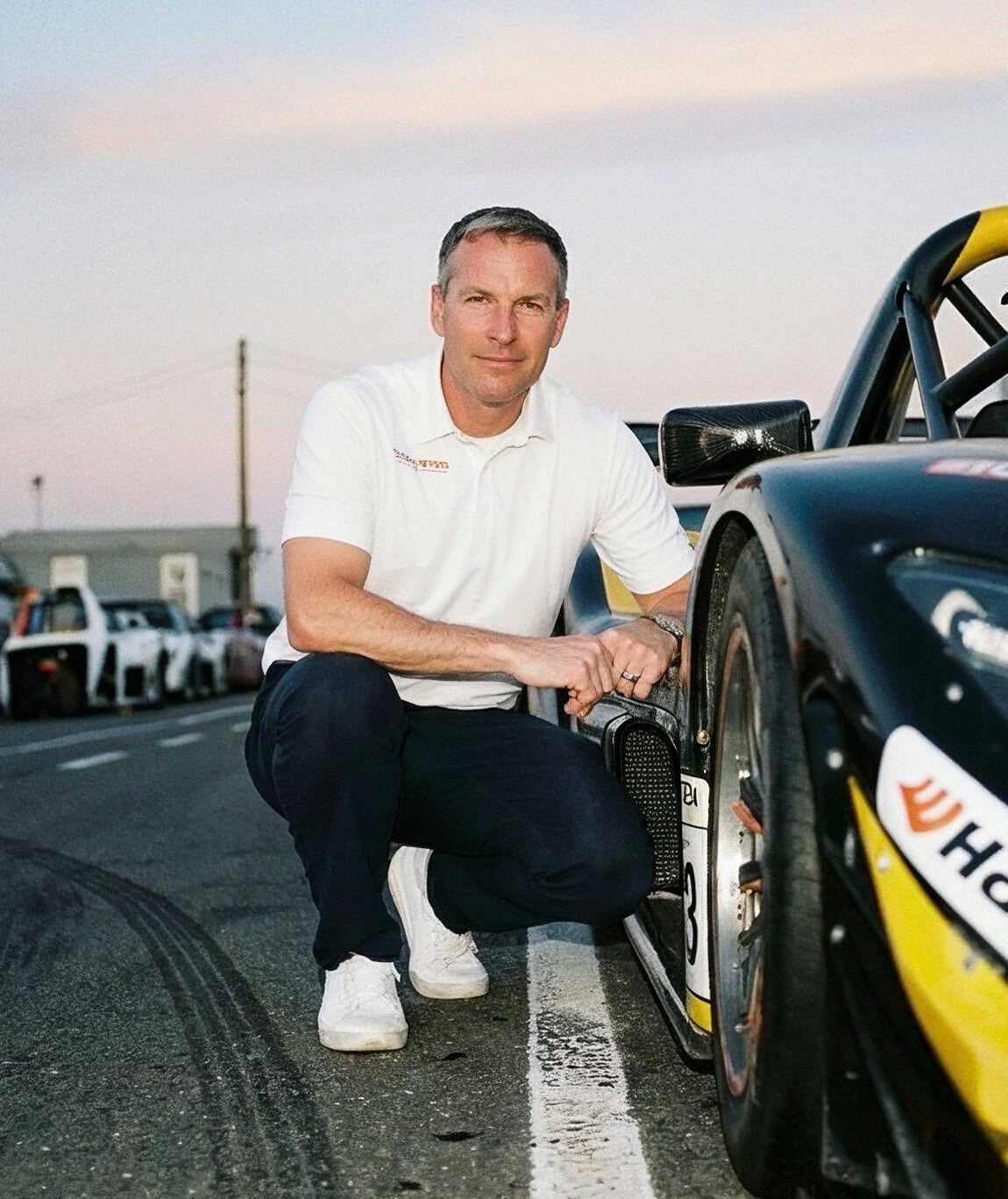 Race car driver by his car
