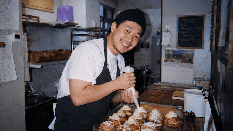 Baker piping cream in his bakery